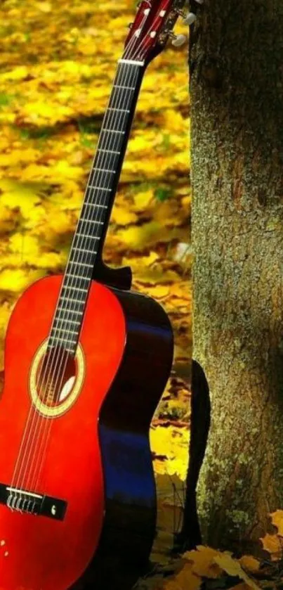 A guitar against a tree with autumn leaves everywhere.