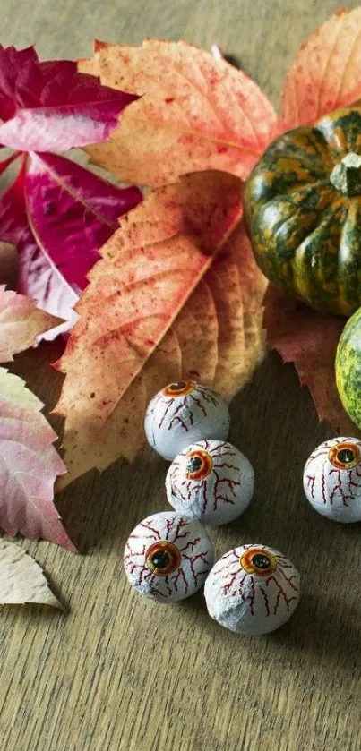 Halloween-themed wallpaper with pumpkins, leaves, and spooky eyeballs.