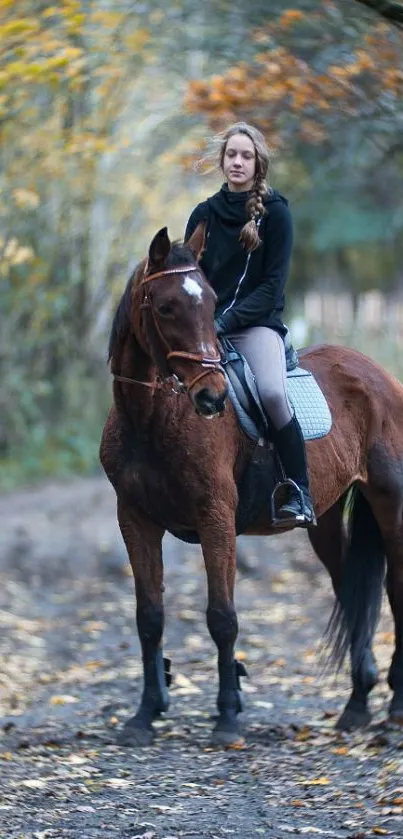 Woman riding a horse on a leafy autumn path.