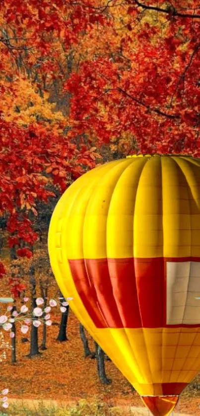 Vibrant hot air balloon amidst autumn foliage.