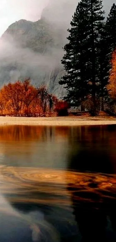 Serene autumn lake reflects vibrant oranges and misty trees.