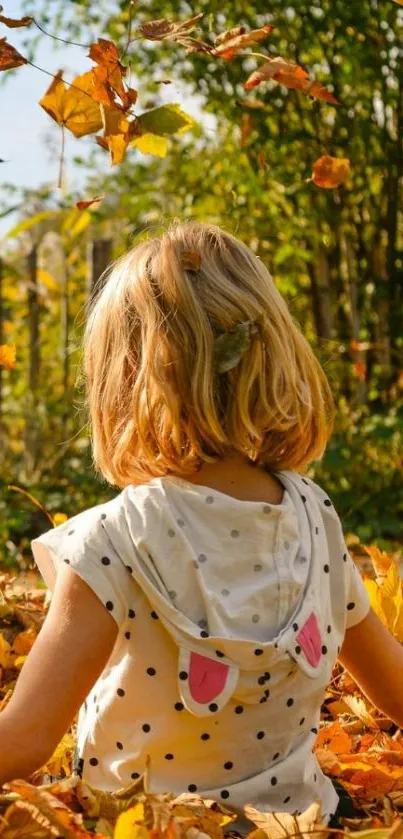 Child playing in vibrant autumn leaves under a tree.