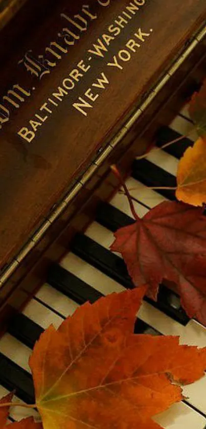 Autumn leaves resting on piano keys with a rustic brown background.