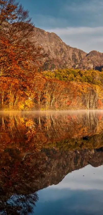 Reflection of autumn trees and mountain on a tranquil lake.