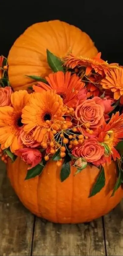 Vibrant orange flowers in a pumpkin vase on wood.