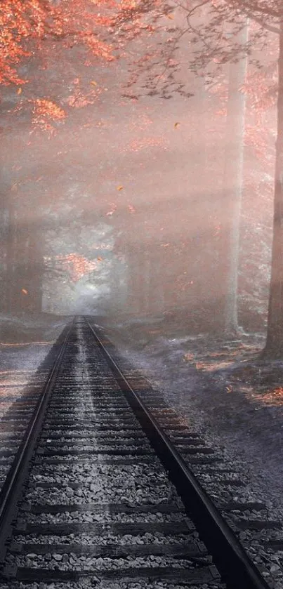 Autumn railway path in misty forest with orange hues.