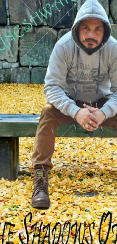 Man sitting on bench with autumn leaves and motivational quote in background.