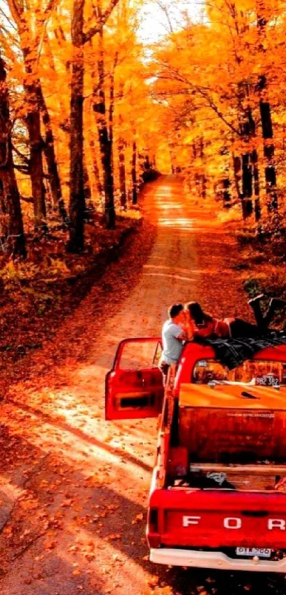 Vintage red truck driving through vibrant autumn forest.