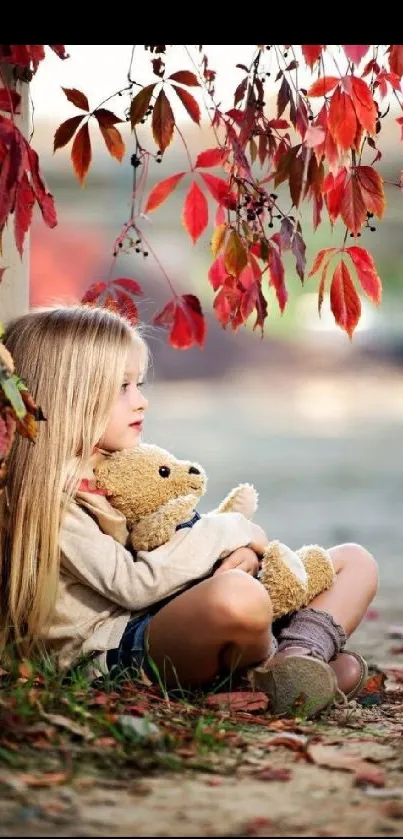 Girl with teddy bear under autumn leaves mobile wallpaper.