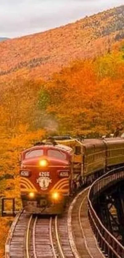 Train crossing a bridge surrounded by vibrant autumn foliage.