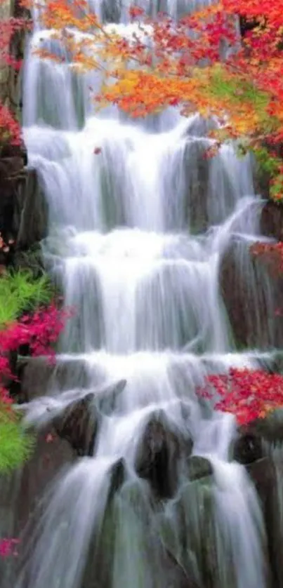 Cascading waterfall with vibrant autumn colors in a serene setting.