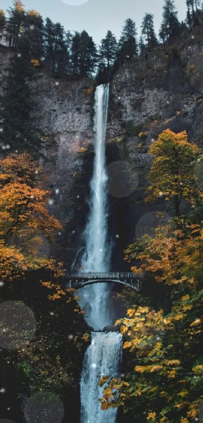 Majestic waterfall in vibrant autumn forest scene.