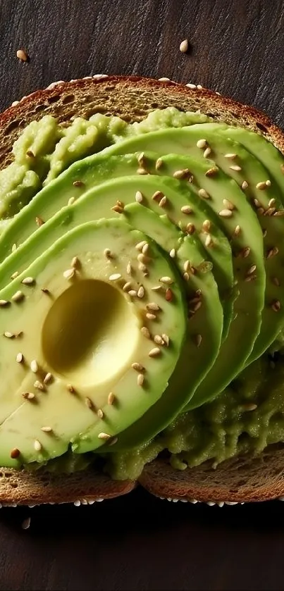 Sliced avocado on toast with sesame seeds on a dark wooden background.