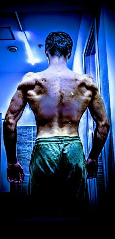 Silhouette of a muscular back in blue light.