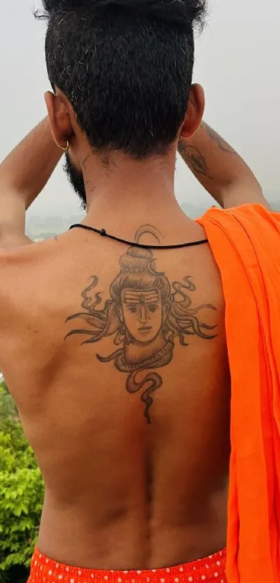 Back tattoo design with spiritual motifs and orange cloth.