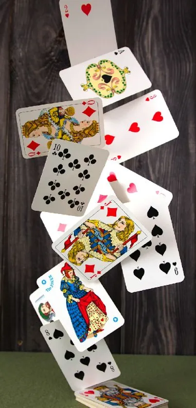 Artistic arrangement of playing cards in balance against a wooden background.