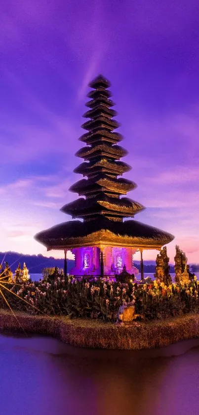 Balinese temple silhouette against a purple sunset sky reflecting on water.