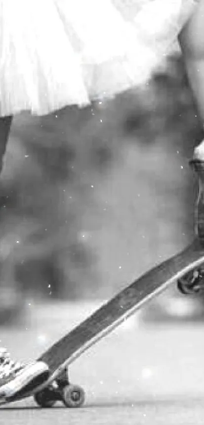 Black and white image of a ballerina and skateboard.