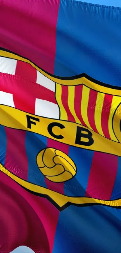 Barcelona Football Club flag waving against a clear blue sky.