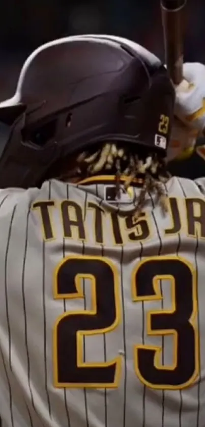 Baseball player in action with a bat, wearing a striped jersey.