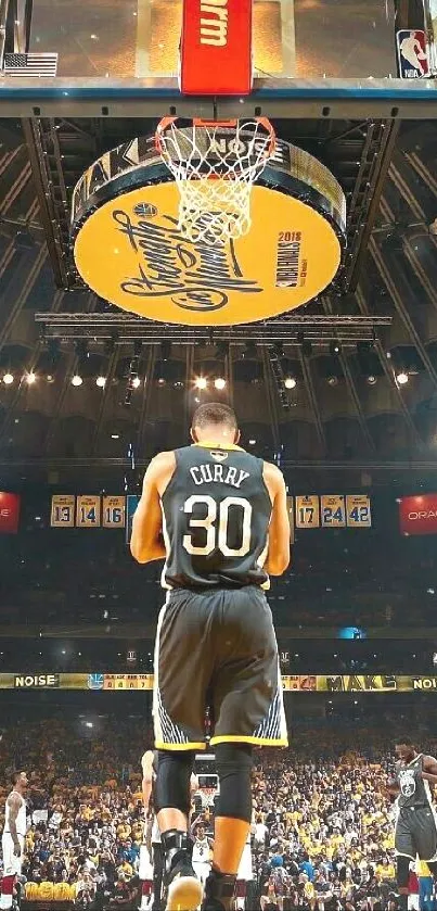 Basketball player on a lit court with spectators in the background.