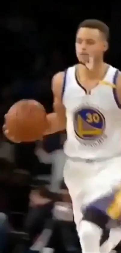 Basketball player dribbling during game with intensity.