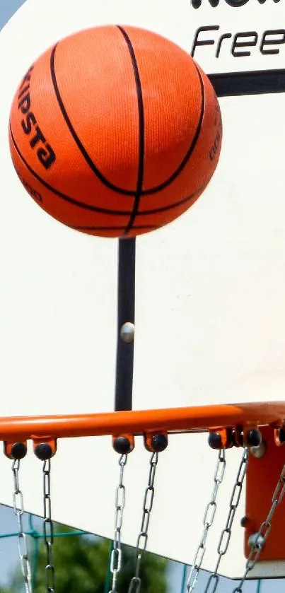 Basketball swishes through hoop on court, captured in action.