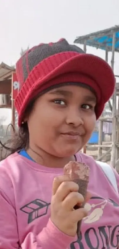 Child enjoying a sunny day at the beach with playful, casual attire.