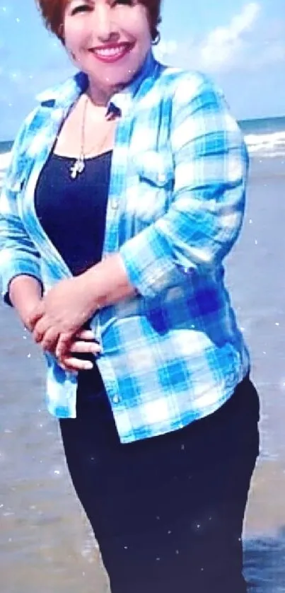 Woman in blue checkered shirt by the sea shore on a sunny day.