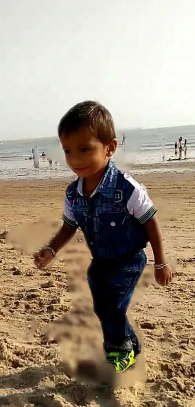 Child playing on a sandy beach with ocean in background.