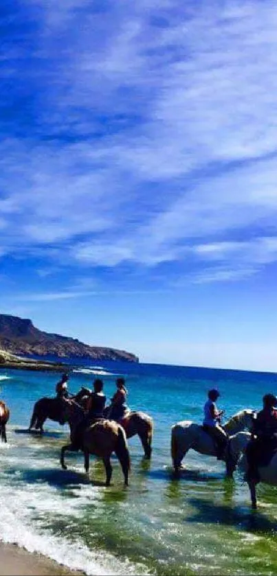 Horseback riding along a vibrant blue ocean under a clear sky.