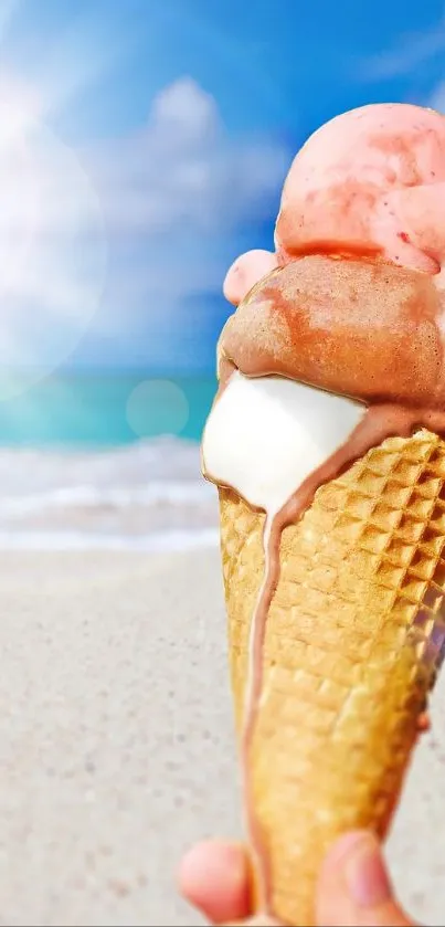 Ice cream cone held on a sunny beach with blue sky.