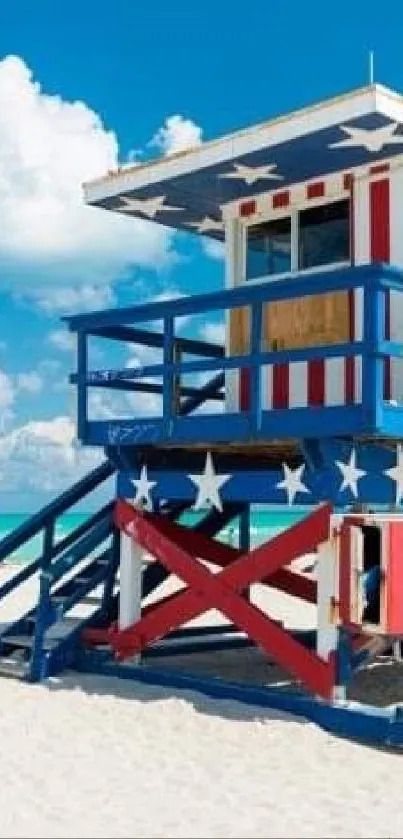 Patriotic lifeguard tower on a sunny beach with blue skies.