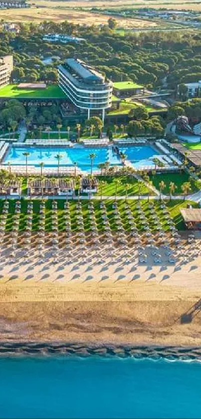 Aerial view of a luxury beach resort with pools and sandy shores.