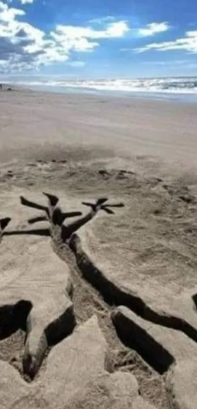 Beach sand art with ocean and blue sky.