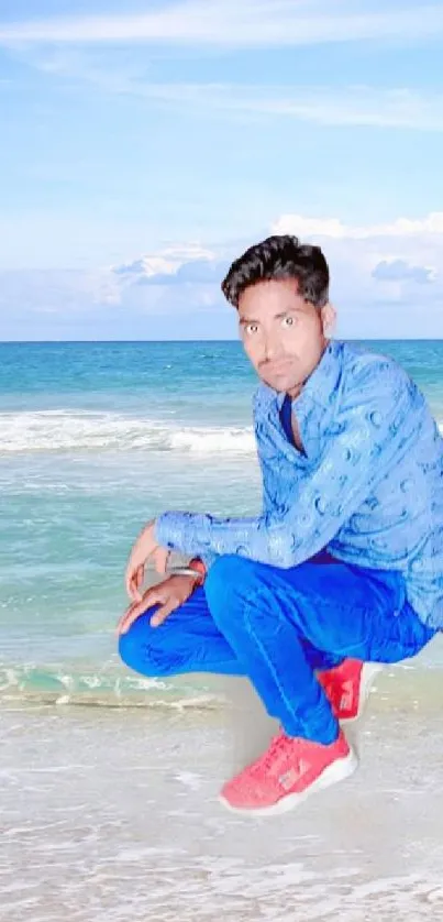 Person in blue outfit on a beach with ocean backdrop.