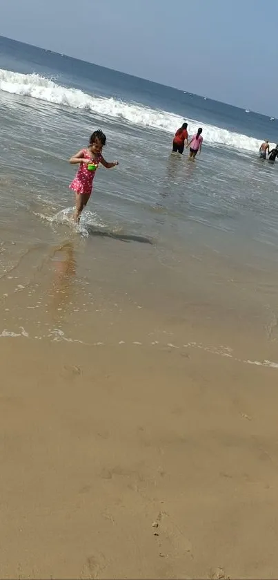 Child playing in ocean waves on a sunny beach.