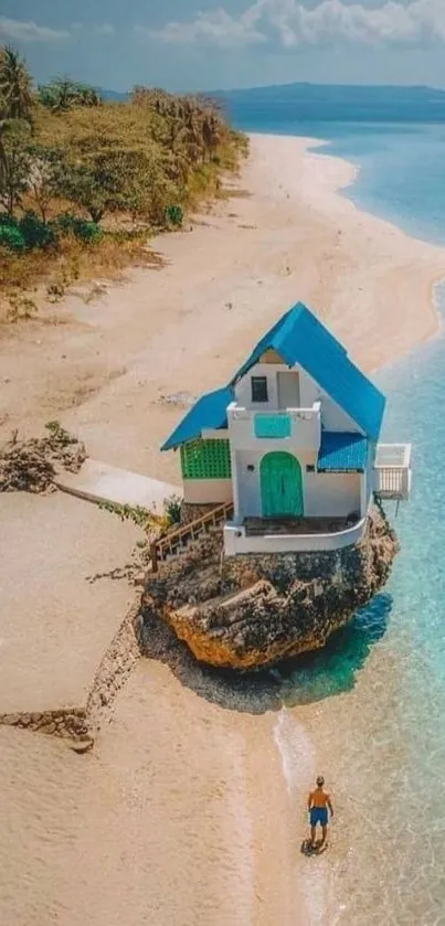 Aerial view of beach with blue-roofed house.