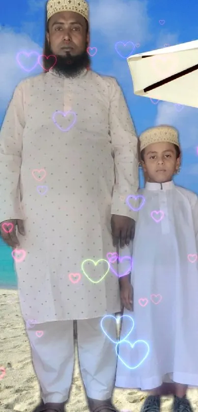 Father and child in white attire at a sunny beach with an umbrella.