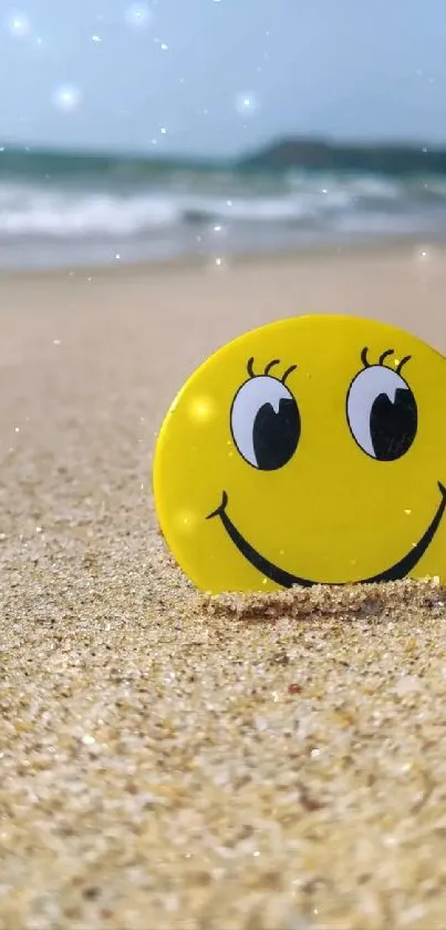 Smiley face on sandy beach with ocean waves.