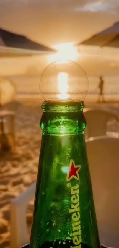 Tropical beach sunset with green beer bottle foreground.