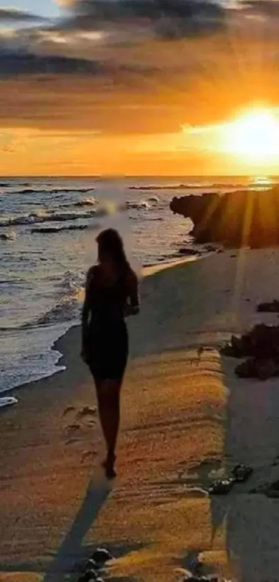 Silhouette walking on the beach at sunset with vibrant orange and gold hues.