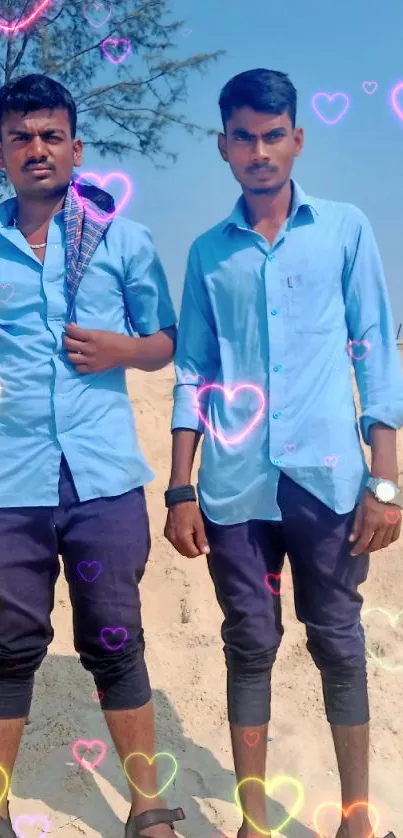 Two men on a sunny beach with colorful heart overlays.