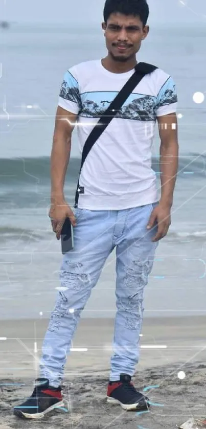 Man on sandy beach with ocean waves in the background, wearing casual summer clothes.