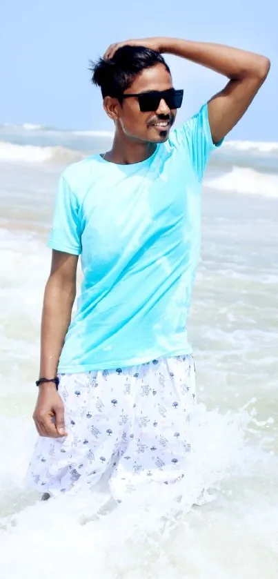 Man enjoying a sunny day at the beach splashing in the ocean waves.