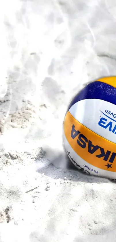 A Mikasa volleyball resting in the sand on a sunny beach.