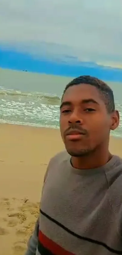 Man enjoying a peaceful beach view with ocean waves.