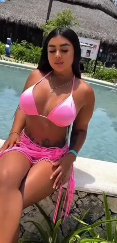 Woman in a pink bikini relaxing by a poolside at a resort.