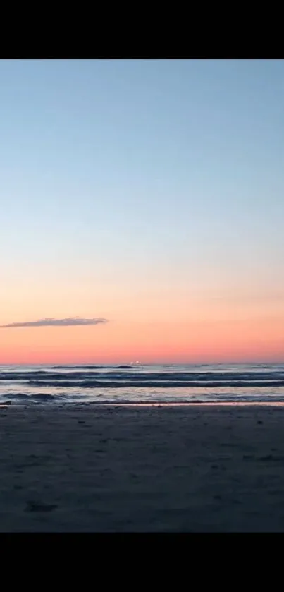 Silhouette person standing on a beach at sunset with ocean waves.