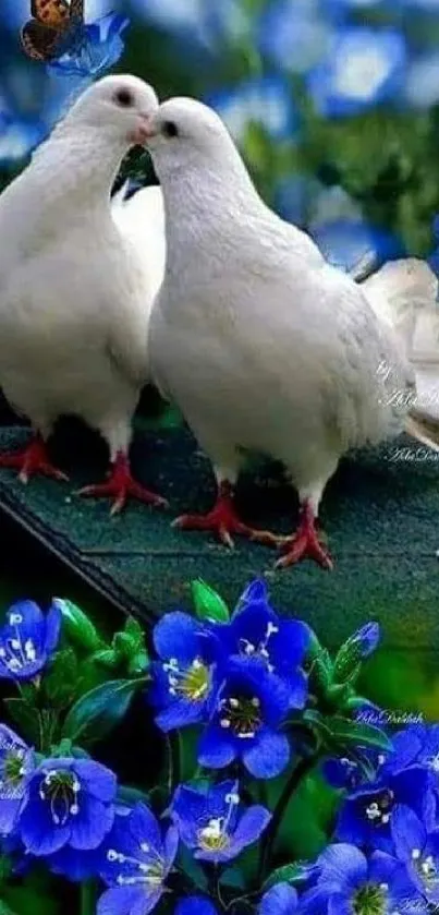 Two white doves among vibrant blue flowers in a serene setting.